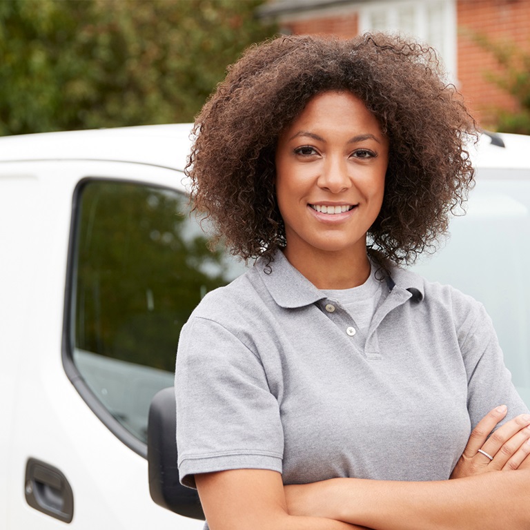 Lady standing by a white van 